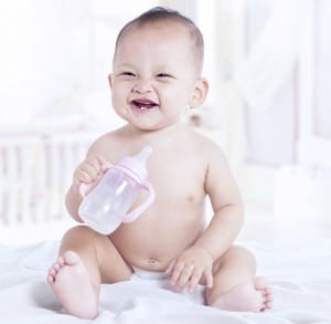 baby smiling with bottle 2