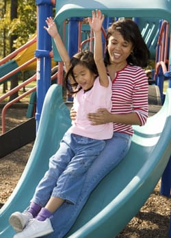 Mom and daughter on a slide. 