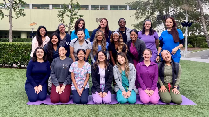 Approximately 20 nurses pose in three rows outside Children's Hospital Los Angeles