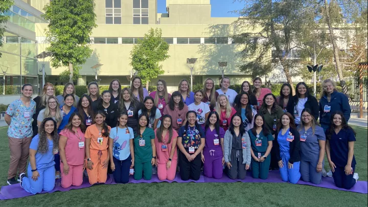 Approximately 40 nurses pose in three rows outside Children's Hospital Los Angeles