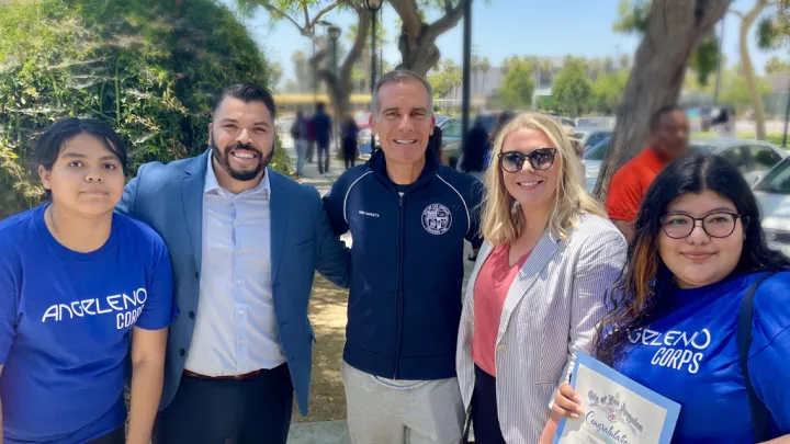 Los Angeles Mayor Eric Garcetti smiles as he stands with members of Angeleno Corps