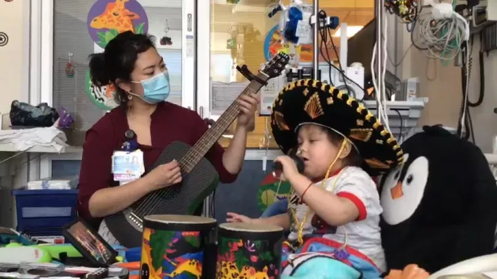 Nano and a CHLA music therapist performing a song together