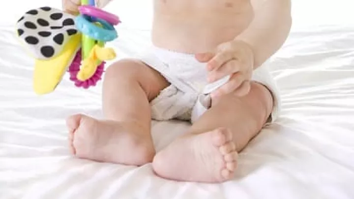 Infant with light skin tone in cloth diapers