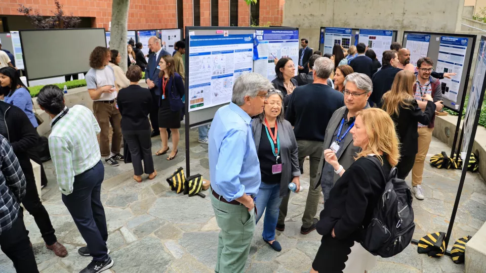 Presenters and attendees review posters at the Saban Research Institute celebration of Science Day 2023