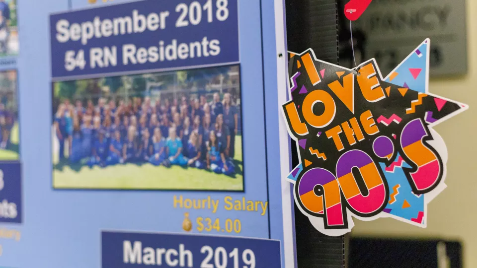 Closeup of a colorful hanging sign says "I love the 90's."