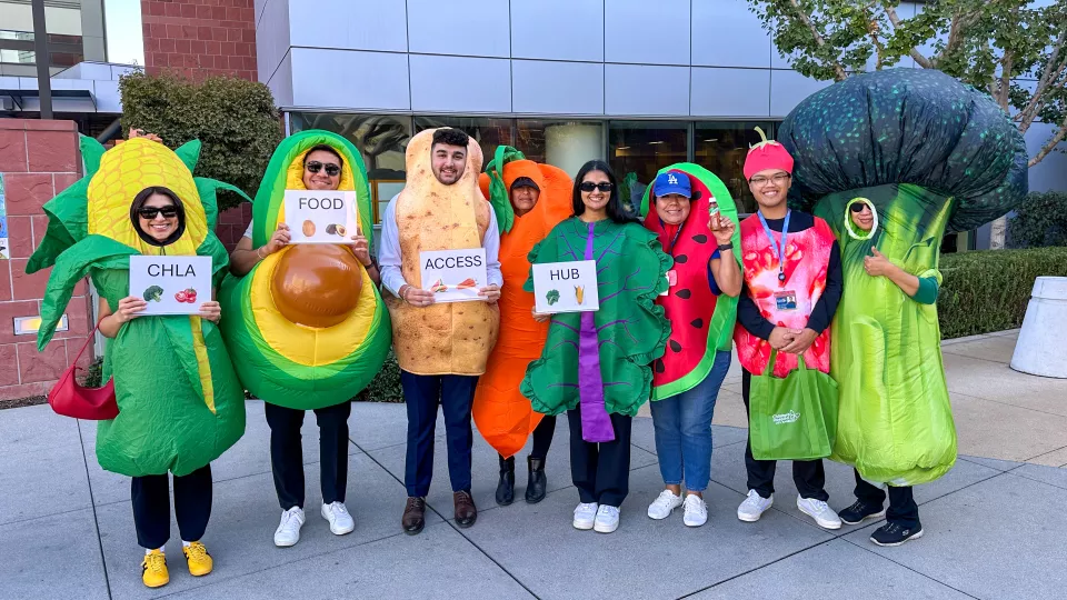 Eight CHLA team members dress as vegetables in CHLA's Food Access Hub for Halloween.