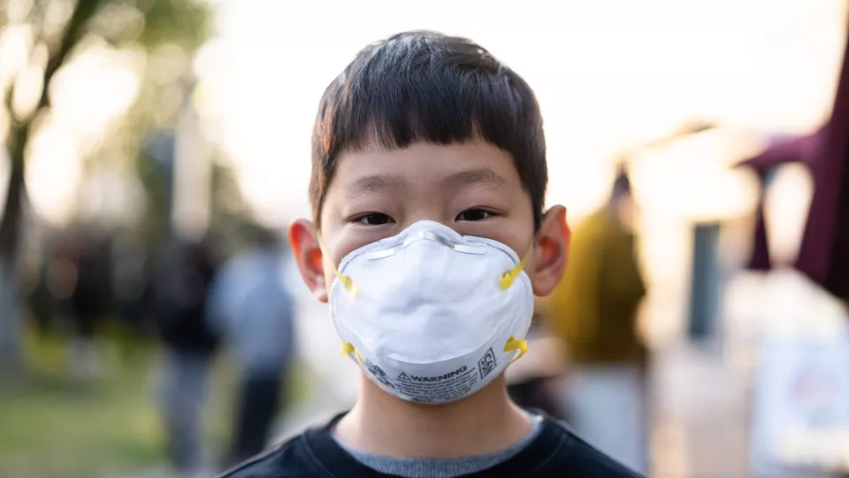 Asian boy wearing KN95 mask