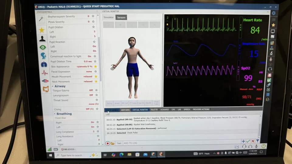 A laptop screen shows the control panel for Hal the medical manikin, including vital signs.