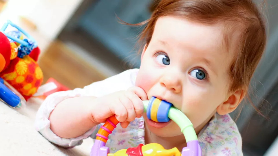 Baby chewing on teething toy