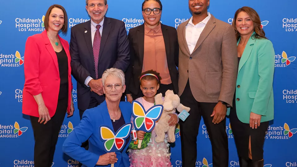 People posing for a photo. From left to right: Alex Carter, Paul Viviano, CHLA patient Ella with parents Megan and Marcus, and Dawn Wilcox