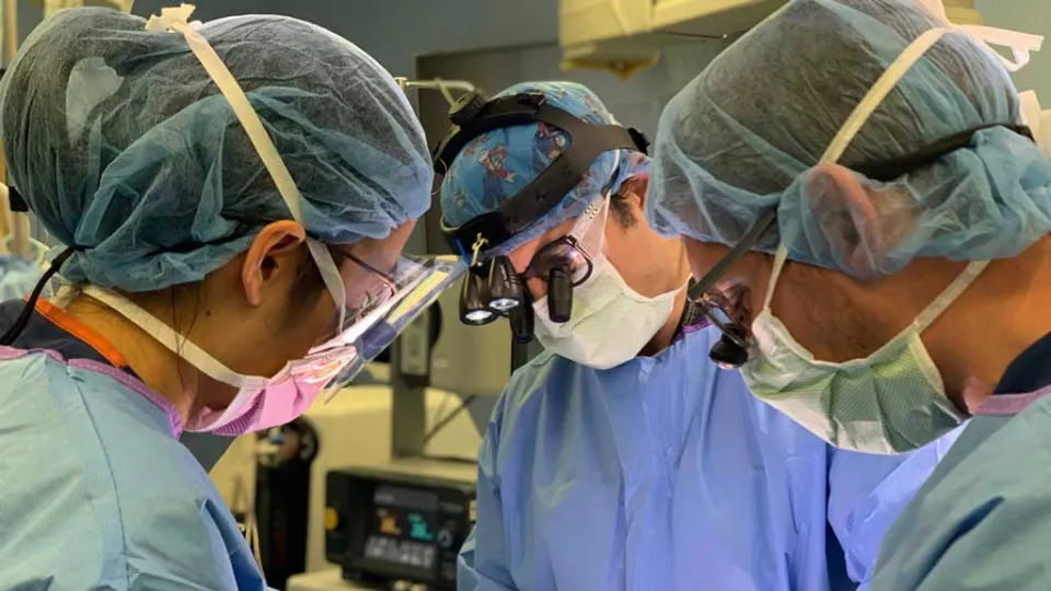 Peter Chiarelli, MD, DPhil and other surgeons at an operating table