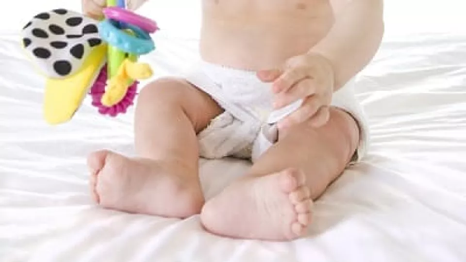 Infant with light skin tone in cloth diapers