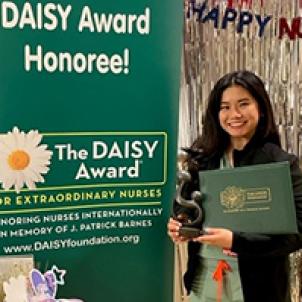 Erika Reyes, RN, poses with her DAISY Award