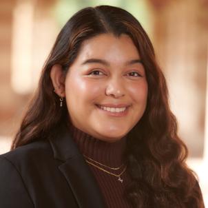 Headshot of Monica Alferez Merino, a young woman in business attire