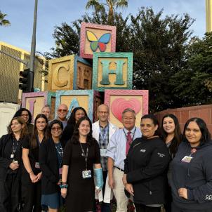Dr. Nagiel poses in front of the CHLA blocks with his retinal gene therapy team. 