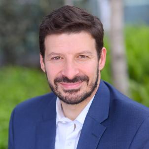 Professional headshot of Yaniv Bar-Cohen, MD, with blurred outdoor background