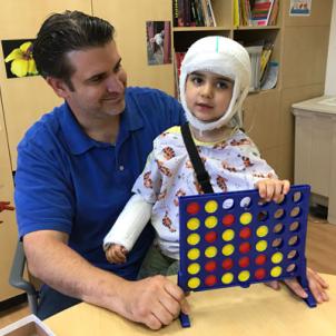 Adrian-playing-Connect-Four-in-playroom.jpg