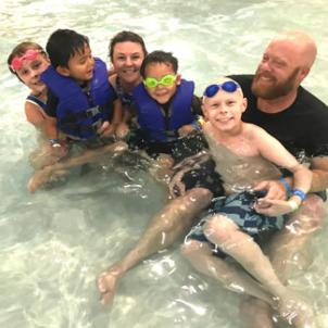 Malakai swimming with his family