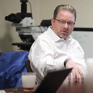 Dr. Judkins sitting at table and talking