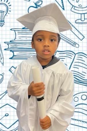 Toddler with medium skin tone and dark hair wears white cap and gown and rolled-up certificate against background of educational imagery icons
