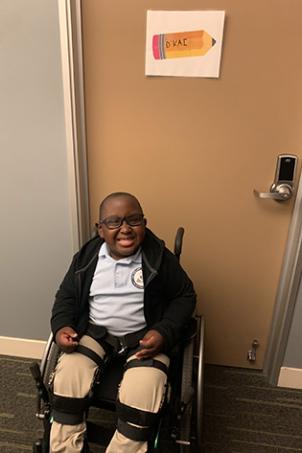 D'Kai sits in his wheelchair outside his Abbott Elementary dressing room