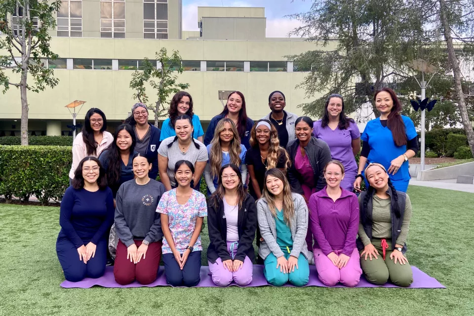 Approximately 20 nurses pose in three rows outside Children's Hospital Los Angeles