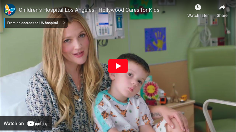Screengrab of YouTube video player displaying actress Drew Barrymore sitting in a hospital bed with a CHLA patient