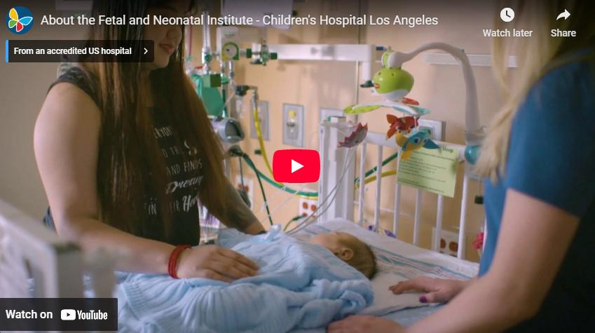 Screengrab of YouTube video player with a young mother and health care worker attending to an infant in a hospital bed