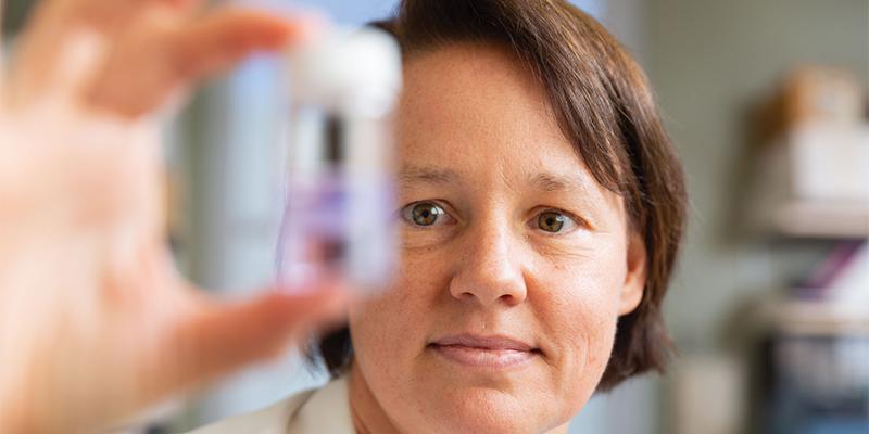 CHLA Researcher Tracy Grikscheit, MD looks at a vial