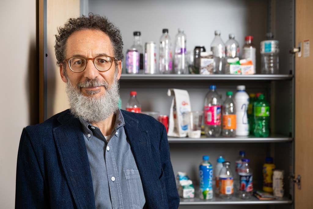 Michael I. Goran, PhD standing in front of shelves containing sugary beverages