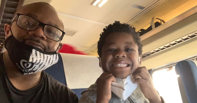 CHLA-Blog-Fathers-Gratitude-Donate-Blood-01.jpg Lawrence and Evan taking a selfie while sitting inside a train
