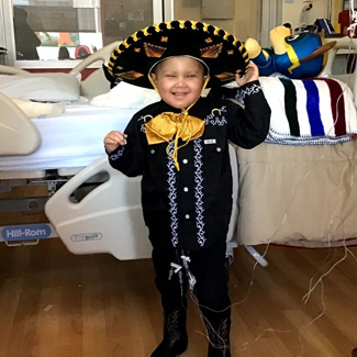 Nano wearing a black and yellow mariachi outfit