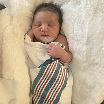 CHLA-Ciara-4-weeks.jpg Ciara, a medium skin-toned infant, sleeps swaddled in a hospital blanket