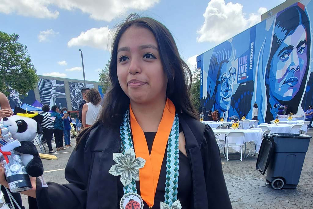 Desiree wearing graduation gown at middle school