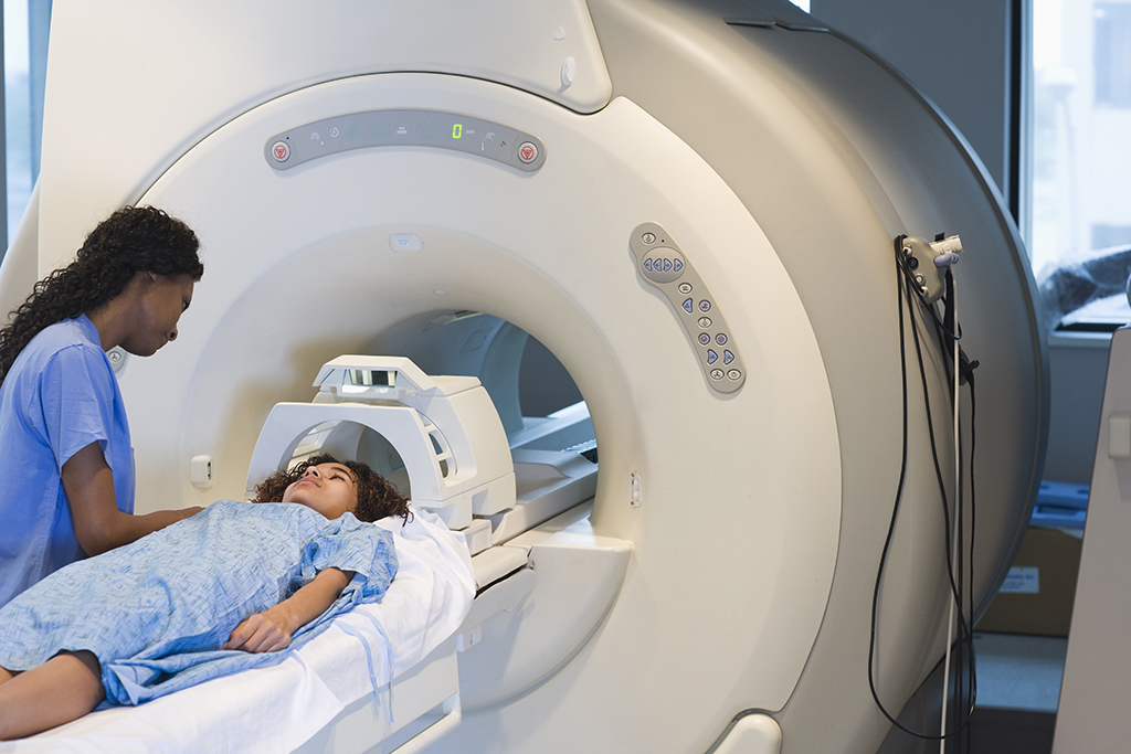 Technician prepares patient for MRI scan