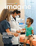CHLA Imagine Magazine Winter 2022 Cover image physician and nurse examining young patient