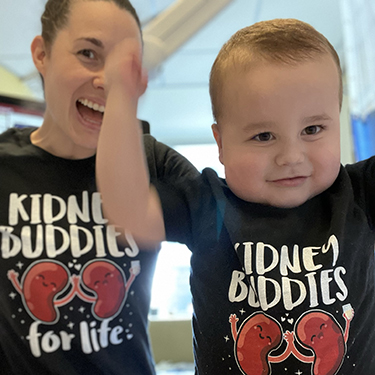 Violet and Oliver cheer while wearing matching kidney donor t-shirts