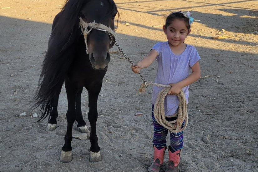 Natalia holding a horse